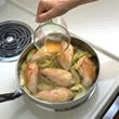Image showing stock being added to pieces of chicken prior to braising